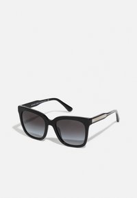 Black square sunglasses with gradient dark lenses. Side accents feature a metallic design. Made from plastic with a glossy finish.