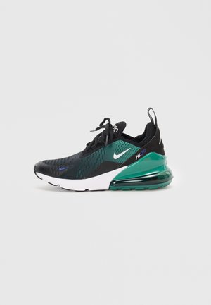 Baskets Nike Air Max en noir et vert avec une tige texturée, une semelle intermédiaire blanche proéminente et un amorti en air vert translucide.