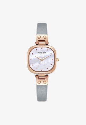 Rose gold square watch with a mother-of-pearl face, gray leather strap, and stud accents. Features rose gold hands and markers.