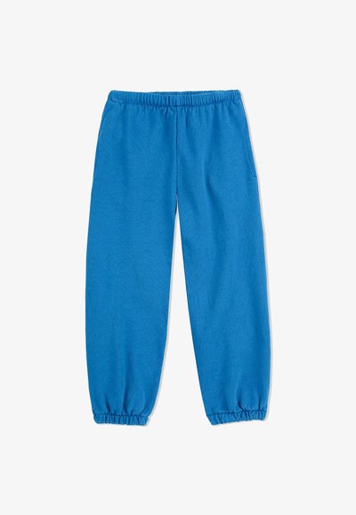 Modré tepláky s elastickým pásom a zhrnutými manžetami na členkoch. Vyrobené z mäkkej bavlny s hladkým povrchom.