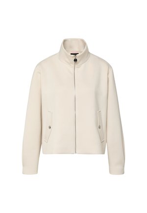 Veste à zip crème avec col montant et deux poches à rabat avec boutons-pression, présentée sur un fond blanc.