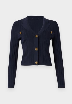 Cardigan côtelé navy à manches longues, design court, col à revers et quatre accents de boutons dorés à l'avant.