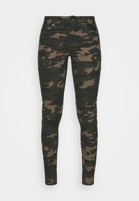 Kamoflagebyxor i mörkgrön och brun, tillverkade av stretchmaterial. Har fem fickor, bältesöglor och dragkedja med knappknäppning.