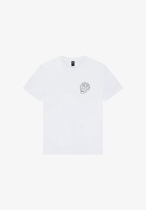 T-shirt bianca a maniche corte con un piccolo disegno nero di un teschio sull'area sinistra del petto, con la parola "DEUS" integrata nel teschio.