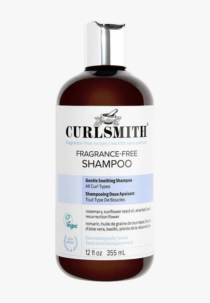 Braune Glasflasche mit einem silbernen Deckel, beschriftet mit "Curlsmith Duftfreies Shampoo." Text enthält Zutaten, Größe (12 fl oz) und ein veganes Symbol.