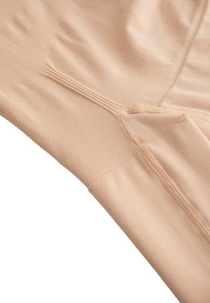Leggings in un leggero beige con una consistenza liscia, dotati di cuciture piatte e una tasca laterale per riporre oggetti. Design classico progettato per il massimo comfort.