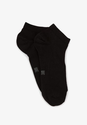 Calzini neri in cotone sino alla caviglia con una texture liscia, caratterizzati da un logo discreto grigio sul lato. Progettati per l'uso quotidiano e il comfort.