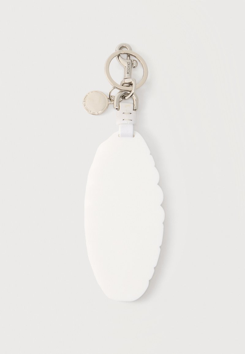 White oval silicone keychain with scalloped edges attached to a silver metal ring and clasp with a small round tag.
