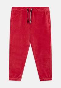 Røde velour joggebukser med elastisk midjebånd og snøring, med innsvingte ben og ribbede mansjetter. Myk tekstur over hele buksen.