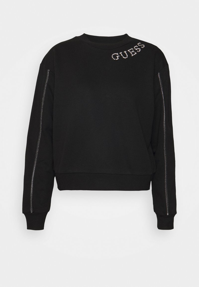 Sweatshirt noir à manches longues avec logo "GUESS" en strass sur l'épaule gauche et des bandes verticales en strass le long des manches.