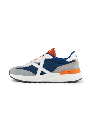 Men's sneakers with a grey suede and navy mesh upper, white accents, orange heel tab, rubber sole, and contrasting laces.