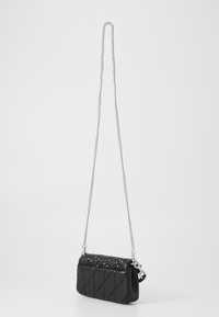 Black quilted handbag with a silver chain strap. Features stud accents and a sleek, rectangular shape. Made of smooth leather.