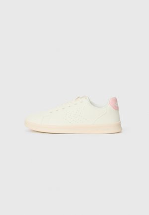 White sneaker made of textured material with a smooth pink heel accent. Features perforations on the sides and a light-colored sole.