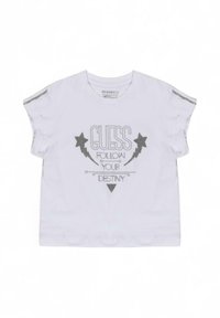 T-shirt bianco a maniche corte con stampa argentata "GUESS FOLLOW YOUR DESTINY" e grafiche di stelle e fulmini. Accenti testurizzati sulle spalle.