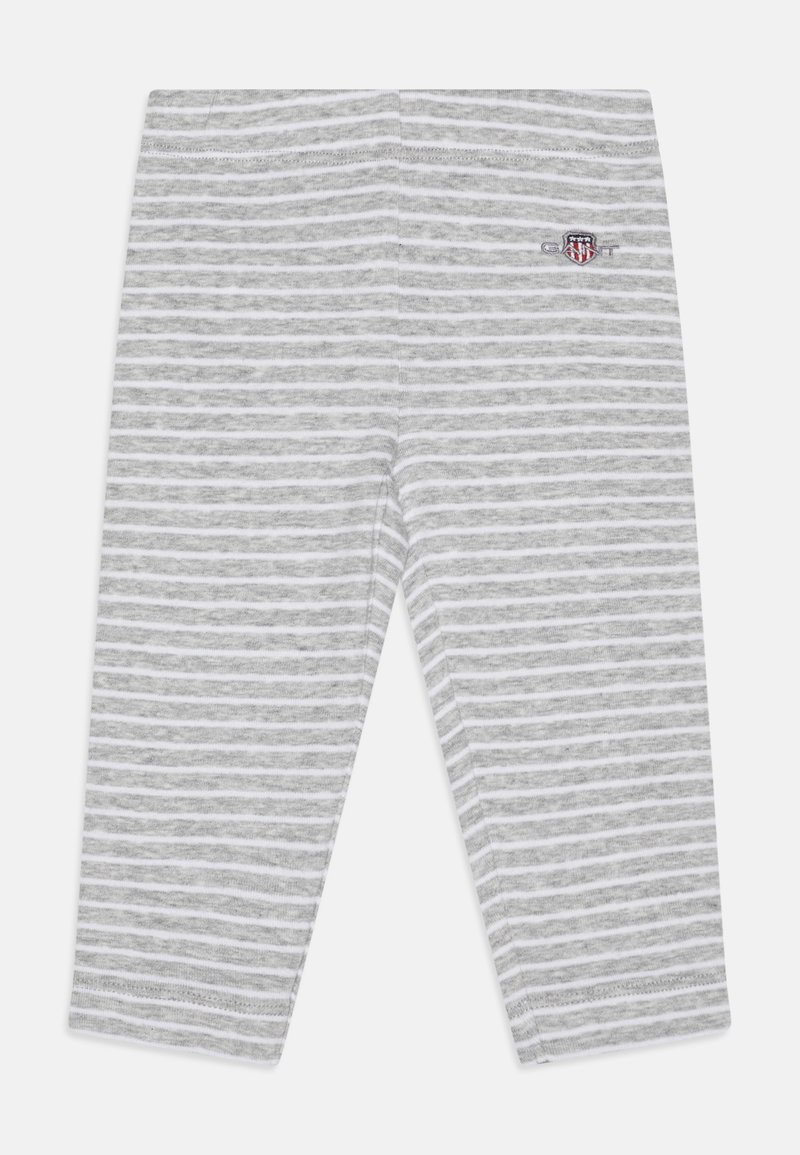 Lys grå leggings med hvite horisontale striper. Laget av mykt materiale, med en brodert logo på siden og en tettsittende design.