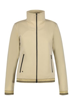 Beige zip-up jacka med hög krage, två sidofickor, svart dragkedja och trim, med guldaccenterade ärmslut och nederkant. Slät textur.