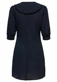 Robe bleu marine à pois blancs, col arrondi à volants, manches ballon et ourlet légèrement évasé, en tissu léger.