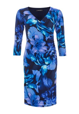 Bloemenjurk met een marineblauwe achtergrond, voorzien van blauw en paarse bloemenpatronen, v-hals en lange mouwen. Gerimpeld detail aan de zijkant.