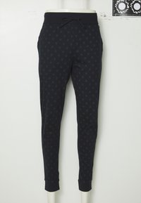 Marineblauwe broek met een subtiel cirkelpatroon, gemaakt van zachte stof, met een trekkoord in de taille en taps toelopende boorden.