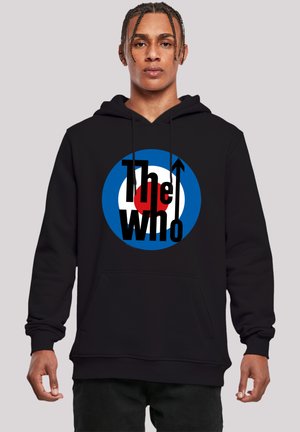 Black hoodie featuring a circular graphic with blue, red, and white colors, prominently displaying the text “The Who” and an upward arrow.