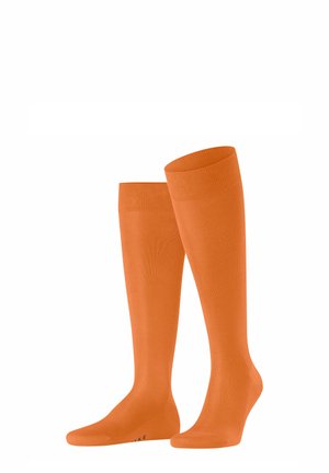 Calze al ginocchio di un vivace arancione, realizzate in tessuto morbido con polsino a coste. Presentano un design della punta senza cuciture per il massimo comfort.
