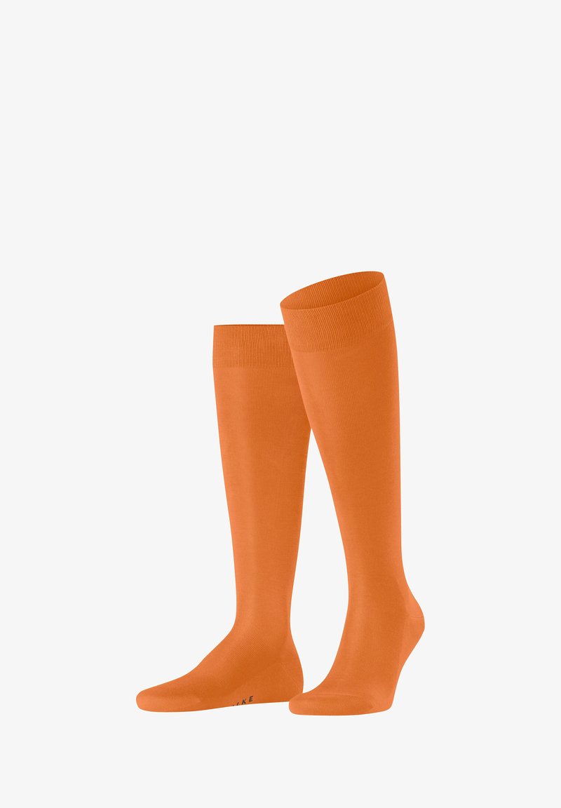 Calze al ginocchio di un vivace arancione, realizzate in tessuto morbido con polsino a coste. Presentano un design della punta senza cuciture per il massimo comfort.