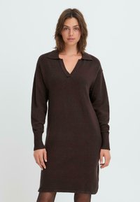 Brown knitted dress with a collared neckline, long sleeves, and ribbed cuffs. The fabric appears soft with a slight texture.