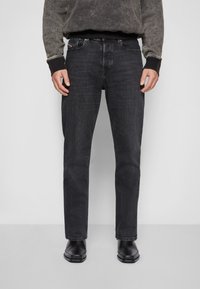 Black denim jeans with a straight-leg fit, featuring a front pocket, belt loops, and subtle whiskering details. Smooth texture.
