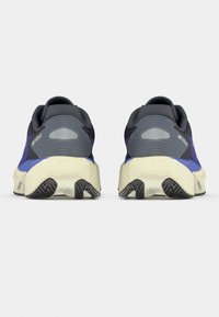 Μαύρα και μωβ παπούτσια για τρέξιμο με υφασμάτινο επάνω μέρος, επενδεδυμένη σόλα και καουτσούκ εξωτερική σόλα. Διαθέτουν έντονο λογότυπο στο πίσω μέρος.