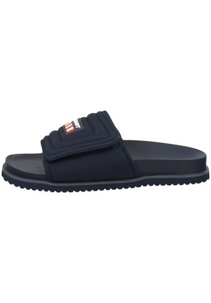 Navy slide sandal with a padded strap and logo detail. Features a textured sole and minimalist design. Made of synthetic materials.