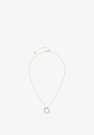 Gold-tone metal necklace with a delicate chain and circular pendant featuring engraved text. Adjustable chain length with a clasp closure.