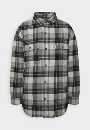 Melna un pelēka kvadrātota flaneles krekls ar garām piedurknēm, apkakli, divām krūšu kabatām un pogu aizdari. Mīksta tekstūra un brīvs piegriezums.