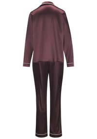Silky burgundy pajama set with long sleeves, pants, and white piping along the collar and cuffs. Smooth texture and tailored fit.