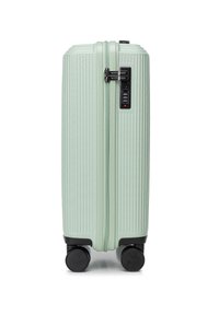Light green hardshell suitcase with vertical ribbed texture, dual zipper, combination lock, and four black wheels for mobility.