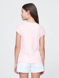 Light pink cotton T-shirt with short sleeves, rounded neckline, and a smooth texture, paired with white shorts featuring hem accents.