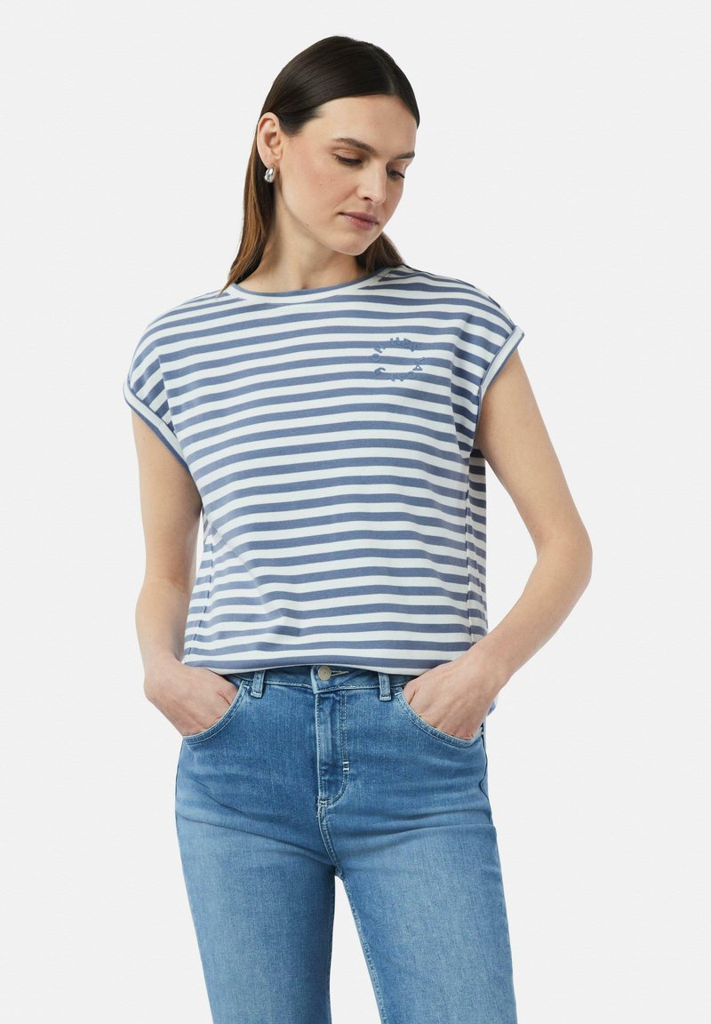 T-shirt en coton rayé bleu et blanc avec des manches retroussées, présentant un petit motif graphique sur la poitrine et une coupe décontractée.