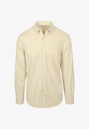 Langärmliges Button-Down-Hemd in hellem Creme mit einer dezenten Rippstruktur und klassischem Kragen mit Knopfverschluss. Kleines Logo auf der Brust.