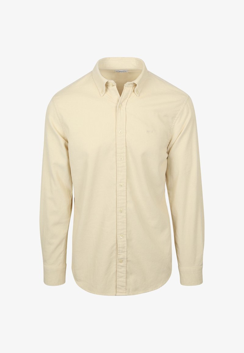 Lange mouwen knoop-overhemd in lichtcrème, met een subtiele ribbelstructuur en klassieke kraag met knoopsluiting. Klein logo op de borst.