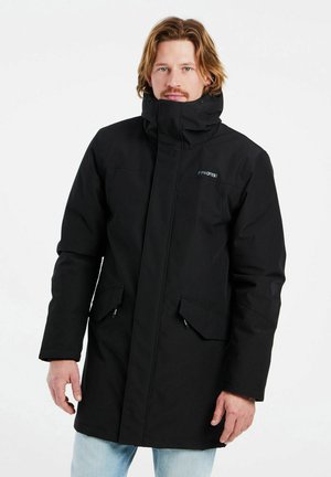Parka noire avec un col haut, des zips et deux poches avant. Fabriquée dans un matériau doux et durable. Design simple et fonctionnel.