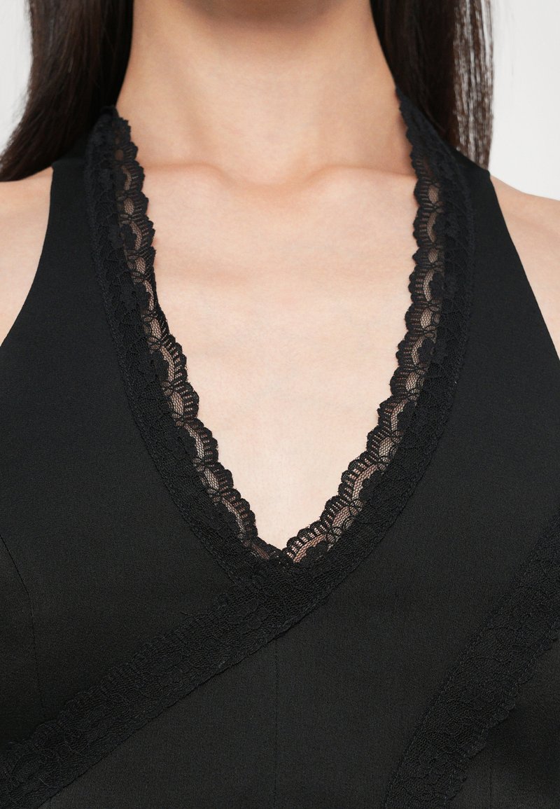 Black dress featuring a deep V-neckline adorned with intricate black lace trim, showcasing a smooth fabric and wrap design.
