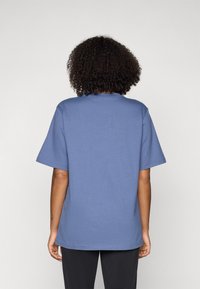 Short-sleeve blue cotton t-shirt with a relaxed fit, crew neckline, and plain texture, showing the back view.