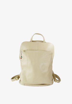 Beige leather backpack with a smooth texture, rounded edges, front zip pocket, and adjustable straps. Features a top handle and decorative tag.