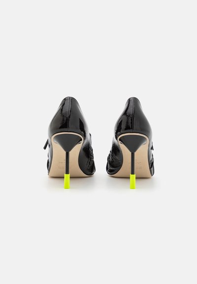 Black patent leather high heels with a pointed toe, featuring a neon yellow heel accent and a smooth, glossy texture.