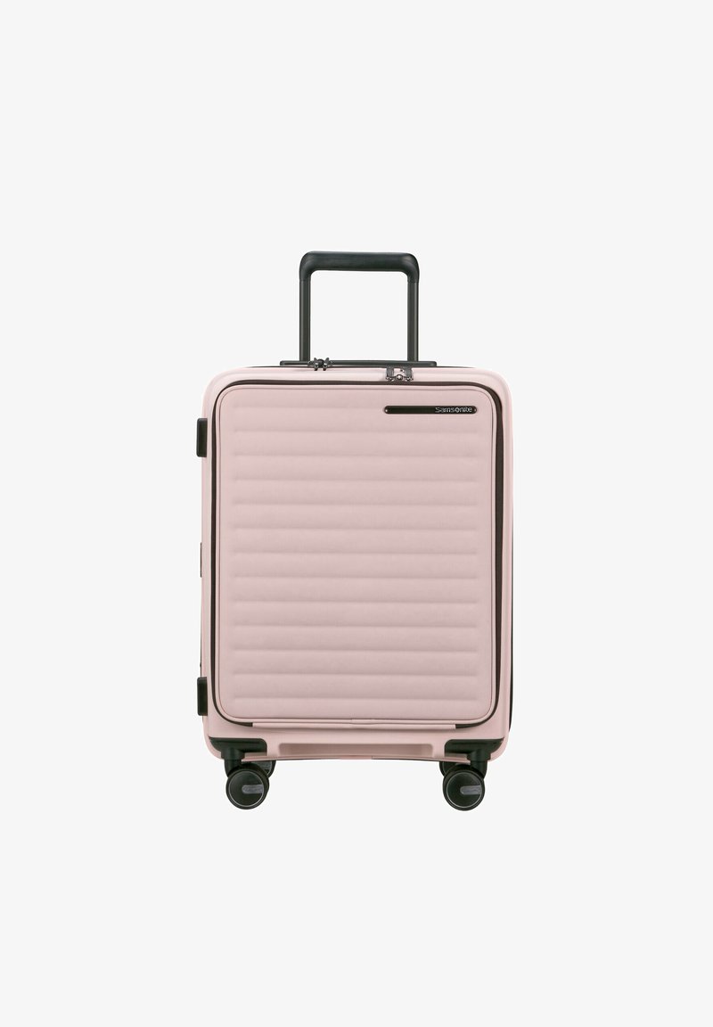 Rosa Hartschalenkoffer mit horizontaler Rillenstruktur, schwarzen Akzenten und ausziehbarem Griff, ausgestattet mit vier leichtgängigen Rollen.