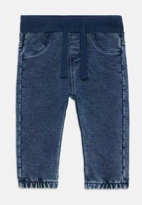 Jeans-Jogginghosen in dunkleblaue Farbe, mit elastischem Bund, Kordelzug und zwei vorderen Taschen, verziert mit fransigen Saumdetails.