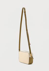 Crossbody bag with a rectangular shape, cream textured body, olive green edges and strap, gold hardware accents, adjustable strap length.