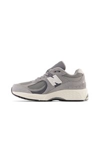 Gray athletic shoe with mesh and suede material, featuring a white "N" logo, textured sole, and a padded collar for comfort.