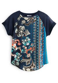 Short-sleeve top with navy blue sleeves. Vibrant floral and geometric patterns in teal, orange, and cream on a dark background. Rounded hem.
