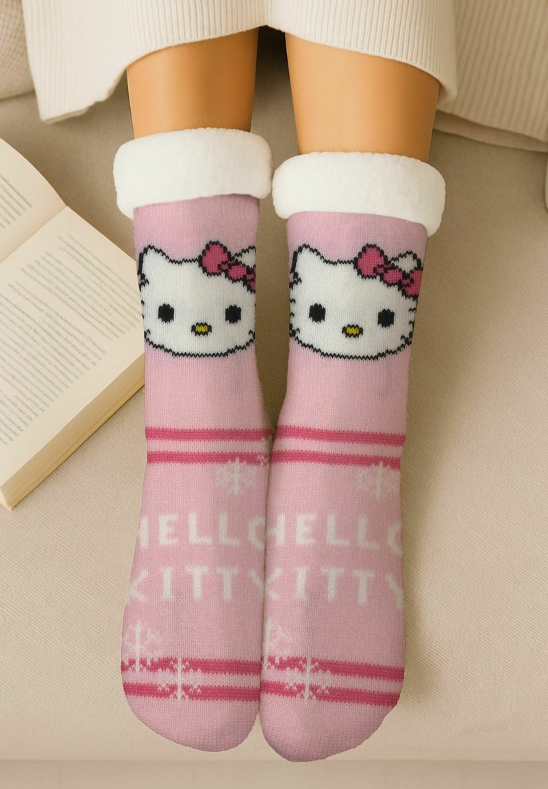 Pink socks featuring a Hello Kitty design with a white fluffy cuff, text that reads "HELLO KITTY" in white, and snowflake accents.
