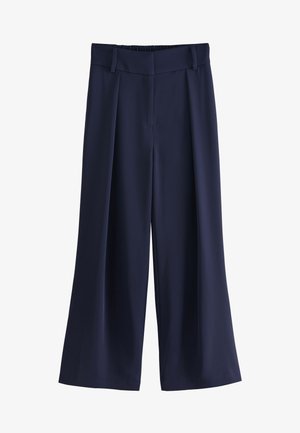 Pantalon large bleu marine avec plis, passants pour ceinture et fermeture avant dissimulée.